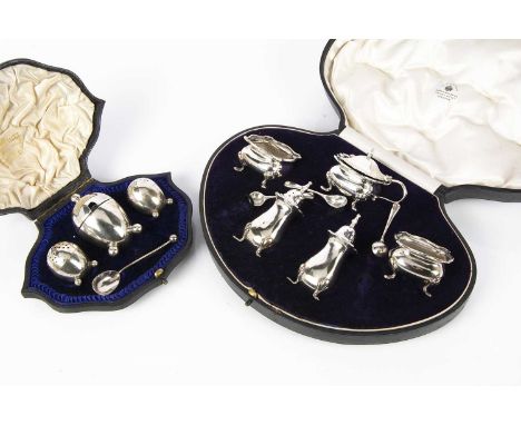 Two cased silver cruet sets from Mappin &amp; Webb, one a five piece set with three small spoons, the other an egg shaped thr