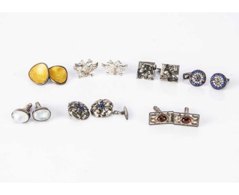 A collection of silver cufflinks, including a pair of Finnish examples of abstract design, a pair of Danish yellow enamel rou