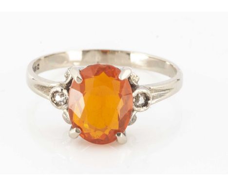 An 18ct gold fire opal and diamond three stone dress ring, in white gold, oval mixed cut fire opal within a four claw setting