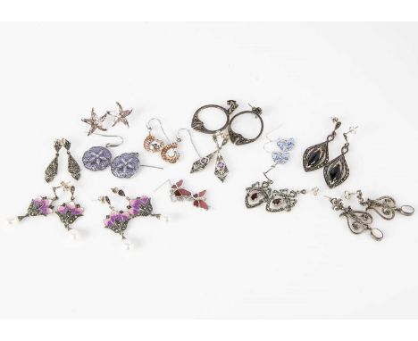 A collection of modern silver and enamel earrings, including a pair of marcasite enamel and drop pearl examples, a pair of on