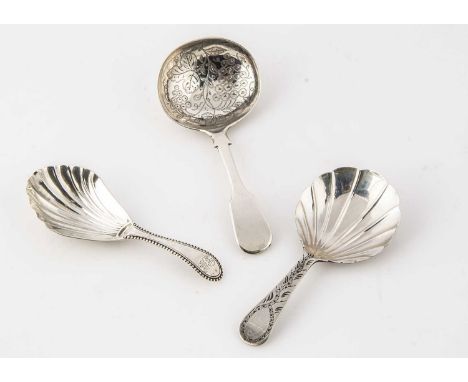 Three Georgian period silver tea caddy spoons, two with shell shaped bowl and one later with engraved bowl and fiddle pattern