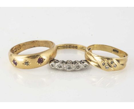 Three 18ct gold rings, including a five stone illusion set ring size O, a diamond set crossover knot, ring size K, a ruby and