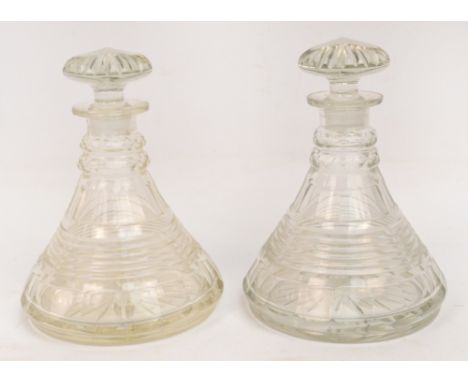 A pair of double ring neck ship's decanters with fluted stoppers and tapering main body, height 23cm.