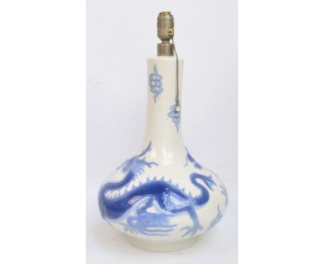 A large Lladro table lamp in the form of a bottle vase with moulded body decorated with two dragons, height 42cm.