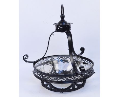 A black painted scrolling ceiling light with cut glass bowl, height of drop approx 53cm (glass af).