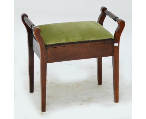 An early 20th century mahogany hinge seated piano stool.