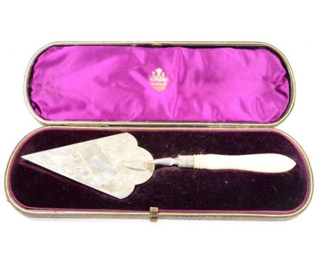 A leather cased Victorian hallmarked silver and mother of pearl handled trowel, the blade engraved with birds amongst floral 