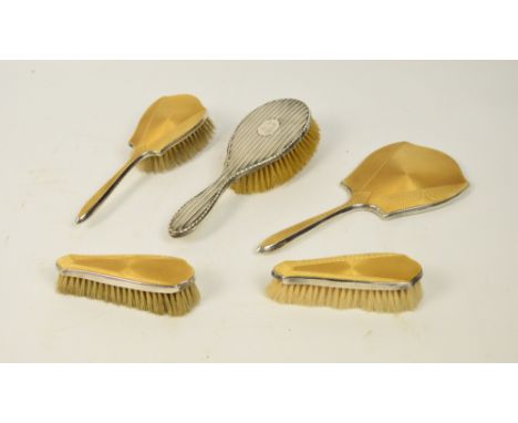 A George V hallmarked silver backed four piece dressing table set comprising hand brush, hand mirror and a pair of clothes br