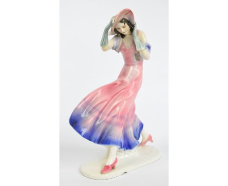 A Goldscheider style figure of a young girl walking in the wind, impressed no.12596 to base, height 31.5cm (af).