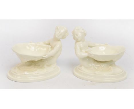 A pair of Royal Worcester Blanc de Chine salts modelled as a merman holding a shell, green printed marks to base, numbered 34