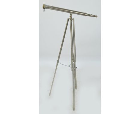 A contemporary unnamed telescope on tripod in polished steel, height of tripod approx 150cm.