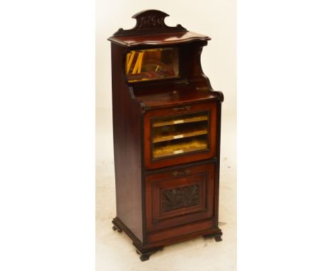 A late Victorian mahogany music cabinet, the raised mirrored back with single shelf above glazed fall front section with thre