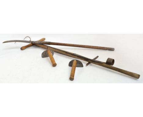 Five vintage garden tools comprising pitchfork, planting device, scythe and two hand hoes.