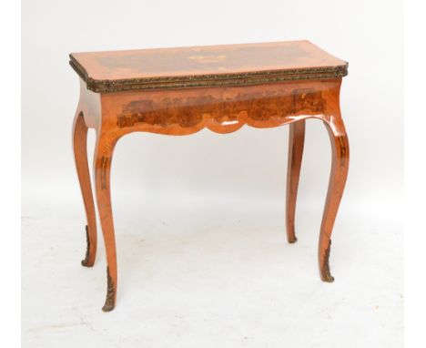 A reproduction inlaid games table, the serpentine outline hinged top opening to reveal a chess/backgammon board with carved d