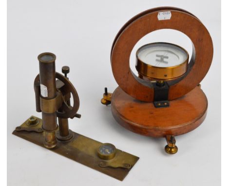 A vintage surveying tool with rotating eyepiece, two spirit levels, a compass, and ruler, and a Griffin of London compass on 