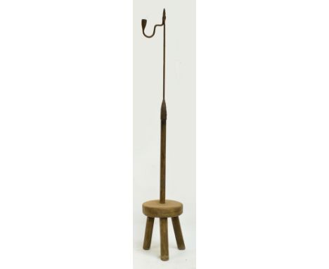 An 18th century and later freestanding wrought iron rush light holder on wooden tripod base, height 124cm.