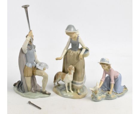 A Lladro figure of an 18th century bearded gentleman on one knee, height 25cm, and two Nao figures of young women (3). CONDIT