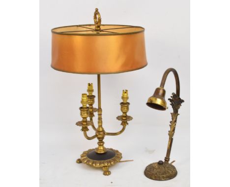 A decorative brass three branch table lamp and a further decorative angled lamp with leaf adorned decoration (2).