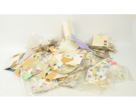 WORLD; A large accumulation of commemorative of first day covers and a quantity of loose worldwide stamps.