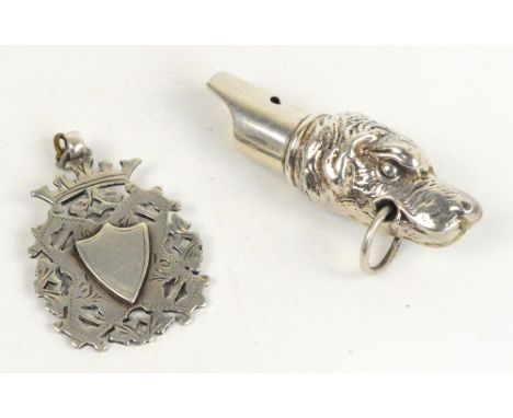 A 20th century white metal whistle modelled as a dog's head, stamped 925 to suspension ring, and a silver pierced and engrave