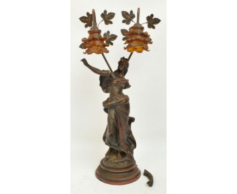 A decorative Art Nouveau style composition figural table lamp modelled as a young woman with two floral branch lights, height