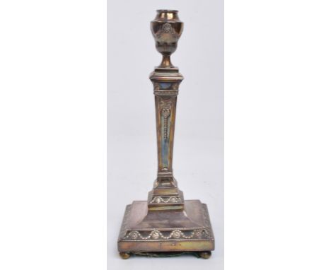 A Victorian hallmarked silver Classical Revival style candlestick with urn shaped scone, raised on square tapering stem to a 