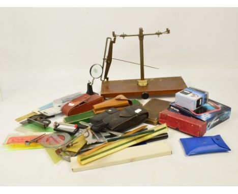 A collection of various instruments including a cased set of drawing instruments, a set of scales, an Abney level, a slide ru