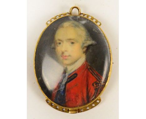 A yellow metal mounted miniature portrait oval brooch depicting a gentleman in red tunic, with upper and lower brackets (for 