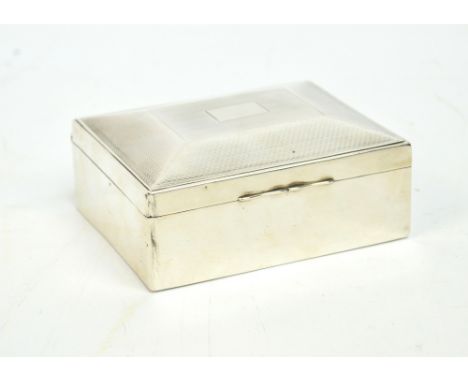 A George V hallmarked silver rectangular cigarette box with raised engine turned hinged lid, W.G. Sothers, Birmingham 1927, w