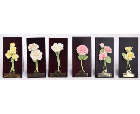 Six Lladro flower models on triangular display plinths comprising rhododendron, rose, begonia, dahlia, dianthus and Californi