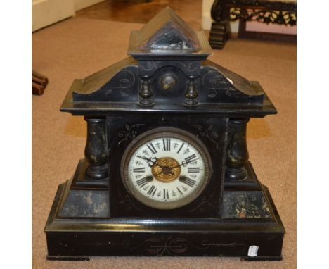 An early 20th century ebonised eight day architectural mantel clock with arched pediment above circular dial set with Roman n