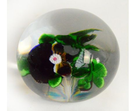 A 19th century Baccarat "Pansy" glass paperweight with floral insert and star cut base, diameter 8cm. CONDITION REPORT: A 2mm
