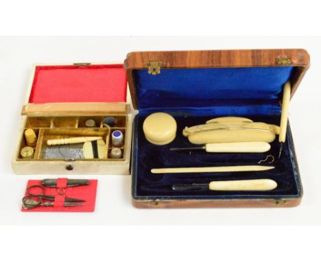 An early 20th century cased bone part manicure set including nail buff and a similar example with a various thimbles and impl