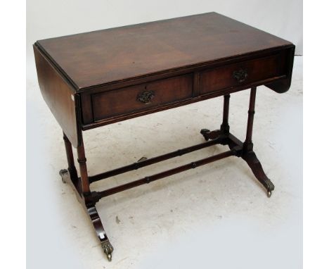 A reproduction mahogany sofa table with rectangular top and twin flaps.