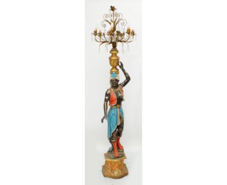 A decorative 20th century Blackamoor figural six branch standard lamp modelled as a Nubian figure beneath a candelabrum decor