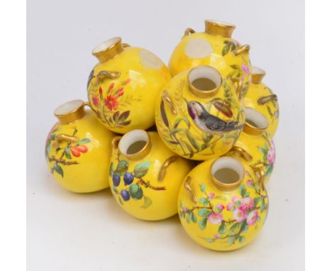 A Royal Worcester porcelain nine section amphora vase group, each twin handled globular vase painted with birds or floral bou
