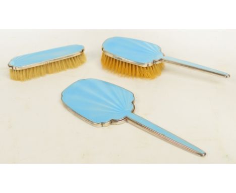 A cased Edward VIII hallmarked silver backed three piece dressing table set with pale blue guilloche enamel over sunburst eng
