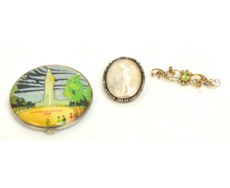 A late 19th century 9ct yellow gold pierced bar brooch, the central peridot surrounded by leaf decoration enhanced by seed pe
