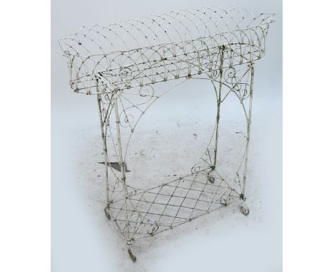 An early 20th century Regency style wirework planter with shelf below, width 76cm.