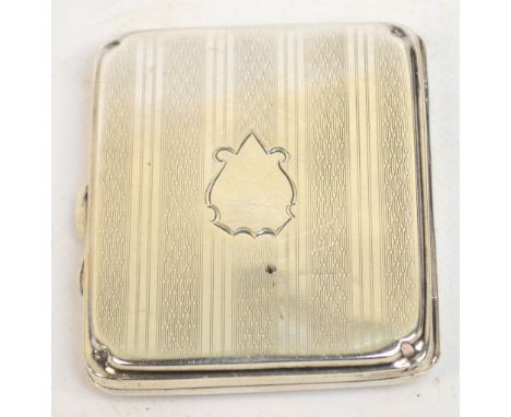 A George V hallmarked silver cigarette case of rounded rectangular form with vacant cartouche to the front, Birmingham 1921, 
