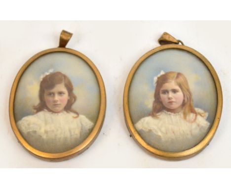 A pair of early 20th century portrait miniatures depicting young girls, 4.5 x 4cm, in fitted easel back case.