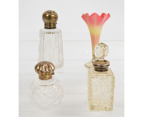 An Edward VII hallmarked silver topped hobnail cut glass scent bottle, William Hutton, Birmingham 1901, and a larger example,