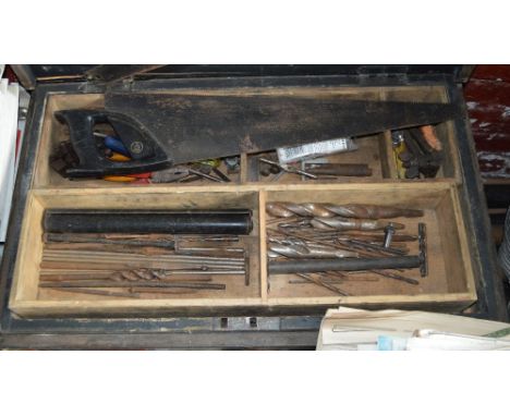 A vintage tool box containing a quantity of woodworking tools.