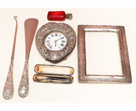A leather and silver cased heart shaped pocket watch holder with pocket watch (af), silver handled shoe horn and button hook,