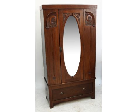 An early 20th century carved mirror door wardrobe.