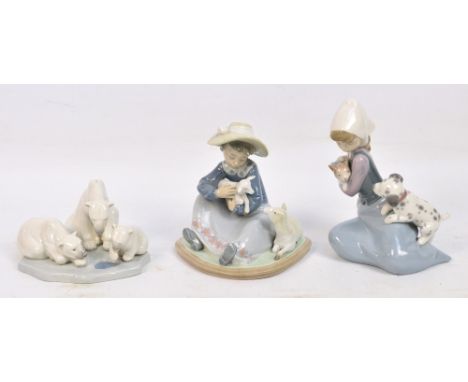 A Lladro figure group of three polar bears breaking ice, width 15.5cm and two Lladro figure groups of seated young woman, one
