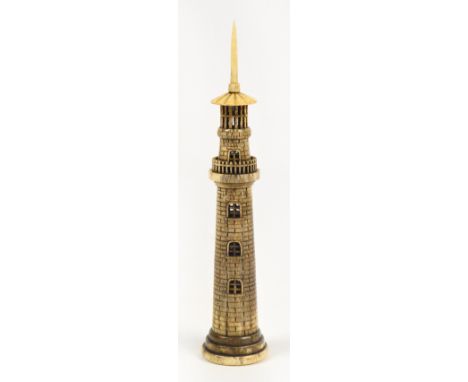 A decorative carved bone lighthouse on stepped circular base, height 17.5cm.