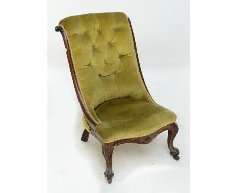 A Victorian walnut button upholstered scroll back nursing chair raised on cabriole front legs.