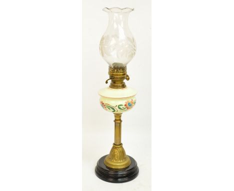 A late Victorian brass oil lamp with lime green glass floral painted reservoir, etched glass shade and circular base, height 