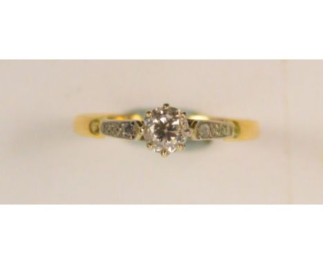 An 18ct yellow gold diamond solitaire ring, the brilliant cut diamond of approx 0.2ct in high claw platinum mount with diamon